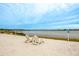 Two chairs on a sandy lakeshore, offering a tranquil view at 11550 Lake Lucaya Dr, Riverview, FL 33579