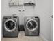 Laundry room with washer, dryer, and shelving at 11550 Lake Lucaya Dr, Riverview, FL 33579