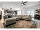 Open living room with sectional sofa, area rug, and views to kitchen at 11550 Lake Lucaya Dr, Riverview, FL 33579