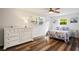 Bedroom with white dresser and floral bedding at 1159 Stewart Dr, Dunedin, FL 34698