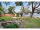 Gray house with a landscaped yard and stone fountain at 1159 Stewart Dr, Dunedin, FL 34698