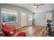 Bright living room with hardwood floors and red chairs at 1159 Stewart Dr, Dunedin, FL 34698