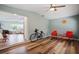 Sunroom with red chairs and hardwood floors at 1159 Stewart Dr, Dunedin, FL 34698