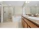 Bathroom features double sinks, soaking tub, and walk-in shower at 12922 Saulston Pl, Hudson, FL 34669