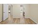 Bright bedroom with wood-look tile floors and access to bathroom at 12922 Saulston Pl, Hudson, FL 34669