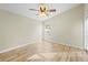 Bedroom with ceiling fan, large window, and wood-look floors at 12922 Saulston Pl, Hudson, FL 34669