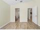 Bedroom with hardwood floors and access to a bathroom and hallway at 12922 Saulston Pl, Hudson, FL 34669