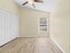 Bedroom with large window, ceiling fan and wood-look floors at 12922 Saulston Pl, Hudson, FL 34669