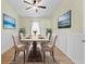 Bright dining room with a spacious table and four chairs, hardwood floors, and wall art at 12922 Saulston Pl, Hudson, FL 34669