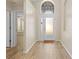 Bright entryway with tile flooring, an arched window, and doors leading to other rooms at 12922 Saulston Pl, Hudson, FL 34669