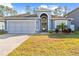 Single-story home with two-car garage and landscaped lawn at 12922 Saulston Pl, Hudson, FL 34669