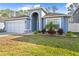 Curb appeal with manicured lawn and neutral color palette at 12922 Saulston Pl, Hudson, FL 34669