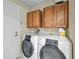 Laundry room with washer, dryer, and upper cabinets at 12922 Saulston Pl, Hudson, FL 34669