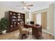 Home office with hardwood floors, built-in shelving, and a desk at 12922 Saulston Pl, Hudson, FL 34669