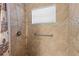 Walk-in shower with grab bars and tile surround at 12922 Saulston Pl, Hudson, FL 34669