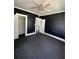 Dark-walled bedroom with ceiling fan and closet at 1311 11Th S Ave, St Petersburg, FL 33705