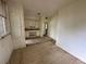 Simple kitchen with white cabinets and a view of another room at 1311 11Th S Ave, St Petersburg, FL 33705