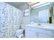 Clean bathroom with floral shower curtain and updated vanity at 1311 Powderpuff Dr # 1003, Dunedin, FL 34698