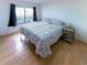 Bright bedroom with king bed and wood floors at 1311 Powderpuff Dr # 1003, Dunedin, FL 34698