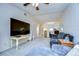 Living room features a large TV and open view to the kitchen at 1311 Powderpuff Dr # 1003, Dunedin, FL 34698