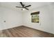 Bright bedroom with wood-look floors and ceiling fan at 13716 Orange Sunset Dr, Tampa, FL 33618