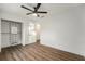 Well-lit bedroom with wood floors and built-in shelving at 13716 Orange Sunset Dr, Tampa, FL 33618