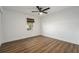 Spacious bedroom featuring wood-look floors and a ceiling fan at 13716 Orange Sunset Dr, Tampa, FL 33618