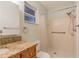 Bathroom with granite countertop, walk-in shower, and grab bars at 13851 102Nd Ave, Largo, FL 33774