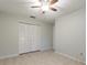 Bedroom with ceiling fan, neutral walls and ample closet space at 13851 102Nd Ave, Largo, FL 33774