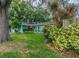 Light teal house with mature landscaping and a spacious yard at 13851 102Nd Ave, Largo, FL 33774