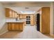 Kitchen with light wood cabinets, tiled floor and black appliances at 13851 102Nd Ave, Largo, FL 33774