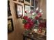 Red roses in a vase on a table with framed photos at 15806 Redington Dr, Redington Beach, FL 33708