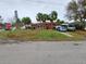 Red house with palm trees and driveway, located on a corner lot at 15806 Redington Dr, Redington Beach, FL 33708