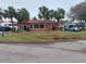 Red house with palm trees and driveway, located on a corner lot at 15806 Redington Dr, Redington Beach, FL 33708