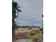 Empty lot with sandy soil and some construction materials at 15806 Redington Dr, Redington Beach, FL 33708