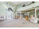 High-ceilinged living area undergoing renovation with spiral staircase at 17077 Dolphin Dr, North Redington Beach, FL 33708