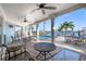 Covered patio with outdoor seating overlooking the pool and waterway at 17077 Dolphin Dr, North Redington Beach, FL 33708