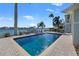 Inviting rectangular pool with a brick patio overlooking the water at 17077 Dolphin Dr, North Redington Beach, FL 33708