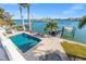 Inviting pool area with patio, dock, and water views at 17077 Dolphin Dr, North Redington Beach, FL 33708