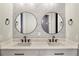 Double vanity bathroom with contemporary sinks and mirrors at 17311 Gunn Hwy, Odessa, FL 33556