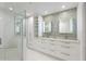 Modern bathroom featuring double vanity, glass shower, and built-in shelving at 175 1St S St # 211, St Petersburg, FL 33701