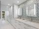 Spa-like bathroom with double vanity, mosaic tile, and large mirror at 175 1St S St # 211, St Petersburg, FL 33701