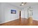 Hardwood floor bedroom with large TV and access to hallway at 175 1St S St # 211, St Petersburg, FL 33701