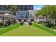 Landscaped lawn with putting green and modern planters at 175 1St S St # 211, St Petersburg, FL 33701