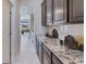 Spacious kitchen featuring granite countertops and dark wood cabinets at 17916 Tavernside Trl, Lakewood Ranch, FL 34211