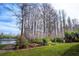 Landscaped backyard with deck and lake view at 18809 Chaville Rd, Lutz, FL 33558