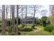 Backyard view showing house with screened patio, landscaping, and trees at 18809 Chaville Rd, Lutz, FL 33558