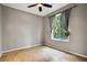 Bedroom with tile flooring, ceiling fan, and large window at 18809 Chaville Rd, Lutz, FL 33558