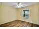 Bright bedroom with wood-look flooring and ceiling fan at 18809 Chaville Rd, Lutz, FL 33558