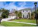 Two-story house with a three-car garage and manicured lawn at 18809 Chaville Rd, Lutz, FL 33558